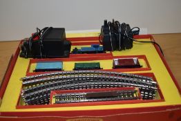 A Triang 00 gauge electric train set, comprising locomotive, three wagons, track, and transformer
