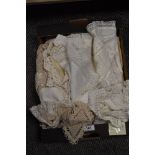 A selection of vintage table linen, including embroidered table cloth and crochet edged mats and