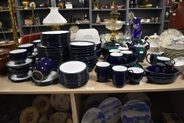 A large collection of Denby in cobalt blue glaze with green bands, comprising; graduated plates,