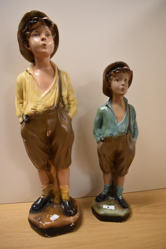 Two early 20th Century kitsch advertising figures, modelled as whistling boys, the tallest measuring