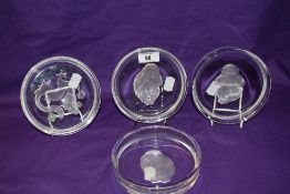 A Hoya crystal glass ashtray, with etched dragon design, together with three further crystal glass