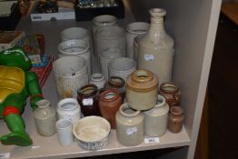 A collection of earthenware marmalade and similar jars, a bottle, jugs and an advertising pot for