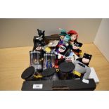 A selection of Warner Bros collectables, including Batman stuffed toys and figurines, badges, key