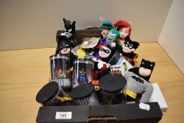 A selection of Warner Bros collectables, including Batman stuffed toys and figurines, badges, key