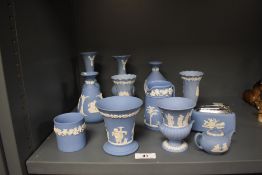 A small collection of blue Wedgwood jasperware, vases, a table lighter, and other items