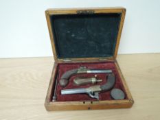 A cased pair of Bentley Liverpool Turn Barrel Percussion Revolvers, drop down triggers, chequered