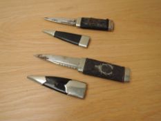 Two Scottish Sgian-dubh with possible Scottish Regimental Badges, blade lengths 9cm, overall lengths