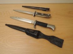 A German WWII Dress Bayonet, blade marked Alcoso Solingen, tip broken, metal scabbard and leather