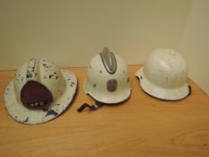 Two German and one American Firemans Helmets, two fibreglass and one steel, one having German badge,