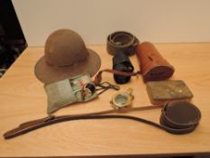 A collection of Military Items, WWII Steel Helmet, WWI Queen Mary Tin, House Wife Kit, Webbing Belt,