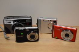 Three digital and one 35mm cameras. A Polaroid IX828, a Fujifilm Finepix F401, a Fujifilm Finepix AV