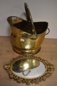 A vintage brass coal helmet and a castcraft cast metal mirror, having gold tone finish.