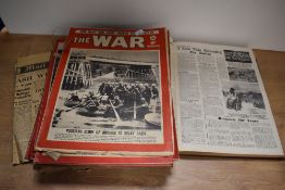 A collection of 'The War' magazine and a book of similar interest.