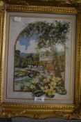 A needlework embroidery of village scene in gilt frame.