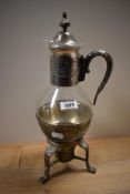 A vintage glass and plated metal tea/ coffee carafe, having receptacle to underside to hold a candle