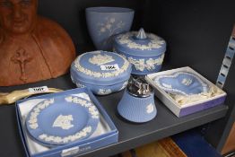 An assortment of blue and white Wedgwood Jasperware, including large trinket boxes, desk top lighter