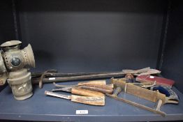 A collection of assorted tools including farier's equipment and a woden side plaine etc