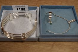 A silver coloured jewellery set, to comprise a matching ring and bangle