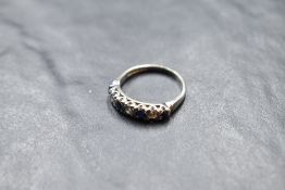 A sapphire and diamond half eternity ring having an illusionary setting on an 18ct white gold