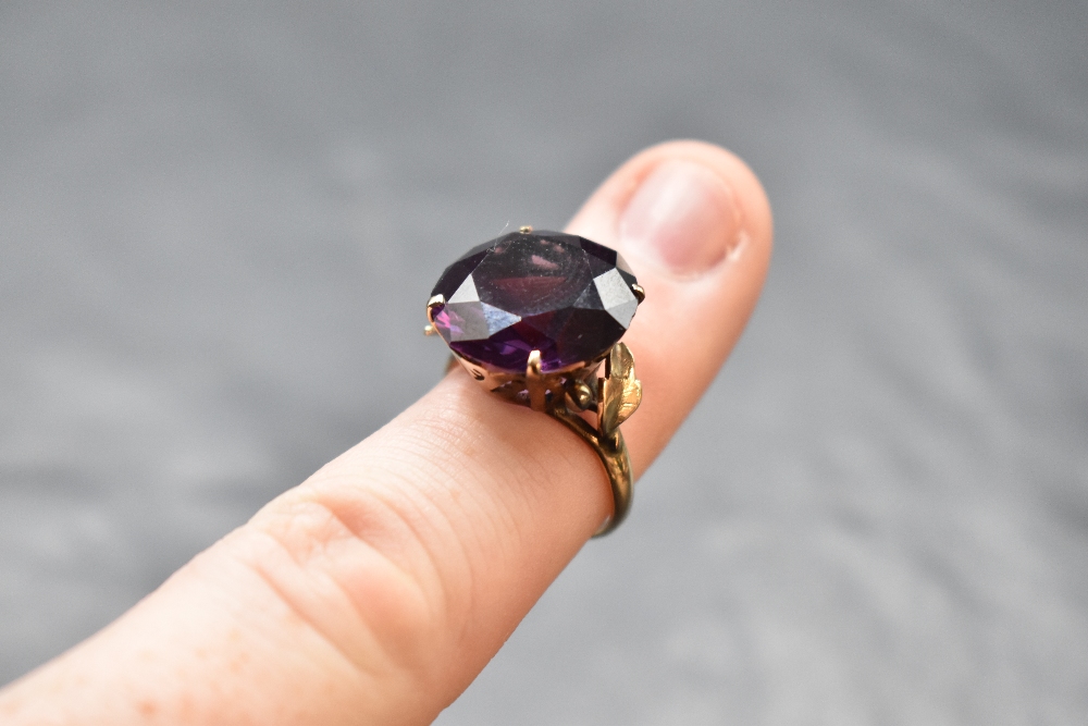 An oversized Alexandrite solitaire ring in a 4 claw basket mount to decorative shoulders on a yellow - Image 2 of 2