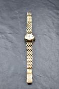 A lady's 9ct gold wrist watch by Longines having a baton numeral dial to champagne face (AF) in a