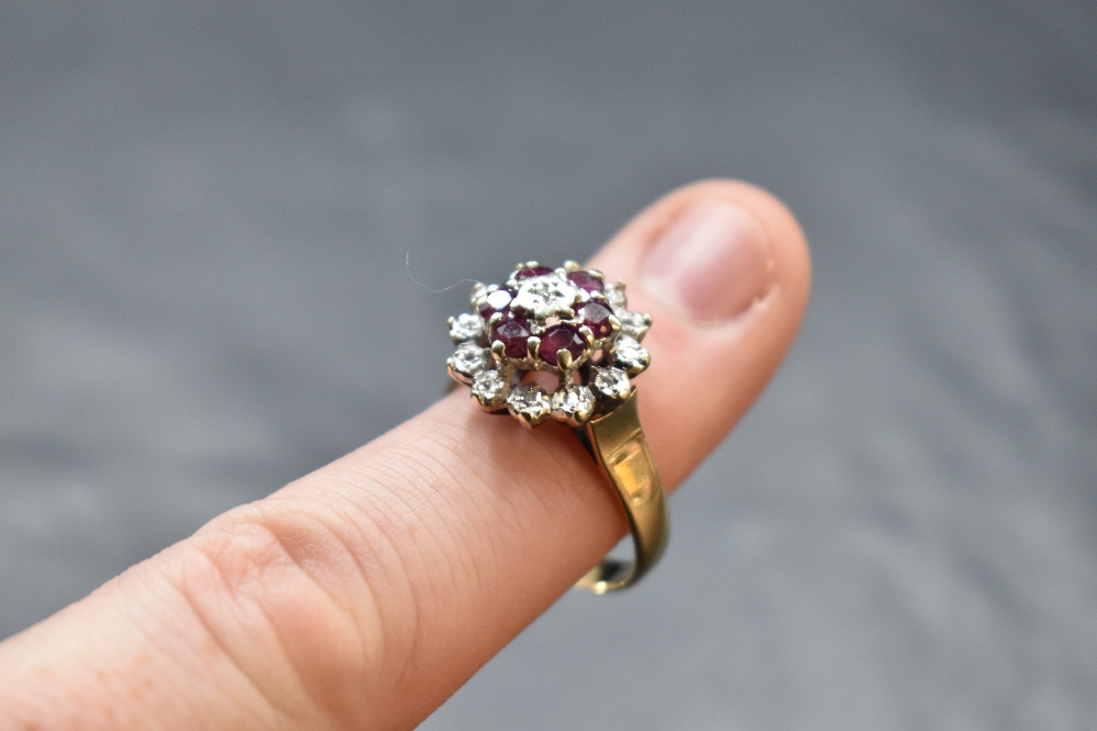 A ruby and diamond chip triple cluster ring having a claw set and illusionary mount on a 9ct gold - Image 2 of 2