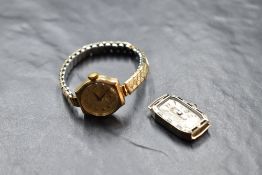 A lady's 9ct gold wrist watch having Arabic numeral dial and subsidiary seconds in a shaped gold