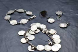 A selection of white metal coin jewellery including bracelets, ring, pendant etc
