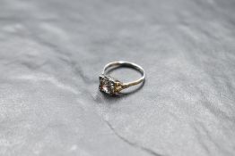 An Art Deco style diamond solitaire ring, approx 1.5ct in a square mount having diamond set