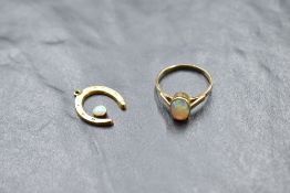 An opal ring having an oval stone in a collared mount on a yellow metal loop, size P, and a 9ct gold