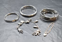 Two HM silver hinged bangles, two baby's silver Christening bangles, a child's silver bracelet and a