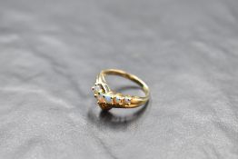 A five stone opal wish bone ring in a claw set mount to moulded 14ct gold loop, size Q & approx 2.