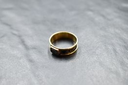 A Victorian 18ct gold mourning ring having black enamelled decoration and small hair panel, size P &