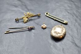 A small selection of yellow metal jewellery including three bar brooches, a locket and small seed