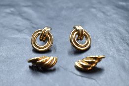 A pair of 9ct gold stud earrings having tubular circular decoration, and another similar pair,