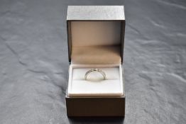 A platinum and diamond full eternity ring having alternate princess and baguette cut diamonds, total