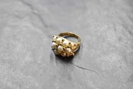 A triple row cultured pearl ring with ball spacers on a yellow metal loop stamped 14K, size N &