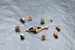 Four pairs of 9ct gold stud earrings of various forms and a yellow metal open pendant having a
