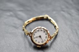 A lady's vintage 9ct rose gold wrist watch having an Arabic numeral dial to white face in circular