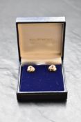A pair of 9ct gold stud earrings having central ruby in moulded mounts, approx 3g