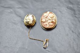 A conch shell cameo brooch/pendant of floral form in a yellow metal mount stamped 14K and a small