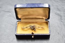 A 9ct gold bar brooch having a central bee with ruby and diamond chip decoration, approx 2.9g