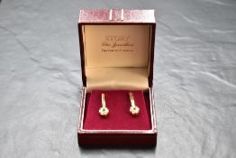 A pair of 14ct gold stud earrings having fixed bar drops to paste clusters, approx 5g gross