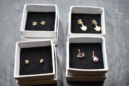 Four pairs of 9ct gold and yellow metal stud earrings of various forms including Canadian Maple leaf