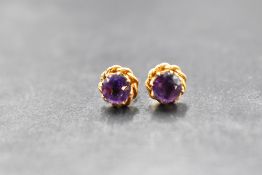 A pair of 9ct gold earrings for pierced ears having heat treated amethyst stones in gold wire