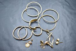 A selection of yellow metal earrings including several hoops and odd stud earrings, approx 9.5g