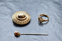 Three pieces of yellow metal jewellery including an artisan style dress ring, brooch with glass