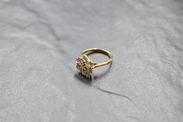A seven stone diamond daisy cluster ring, total approx 1.5ct, in a raised claw set basket mount on