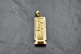 An 18ct Egyptian gold hieroglyphics pendant possibly spelling the name Avril, approx 9.3g