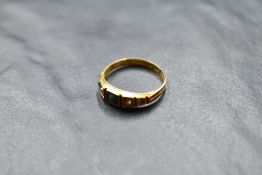 A Victorian band ring having turquoise and seed pearl decoration (one stone missing) on a 15ct